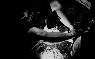 Hands tying running shoes, black and white